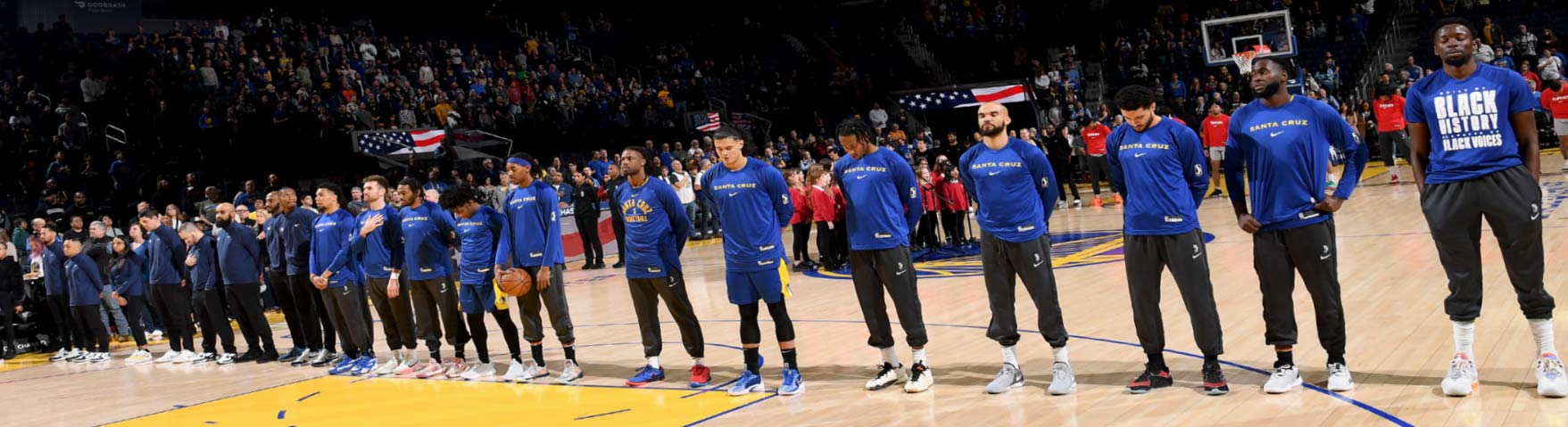 Santa Cruz Warriors on court standing in a line during the National Anthem before a game.