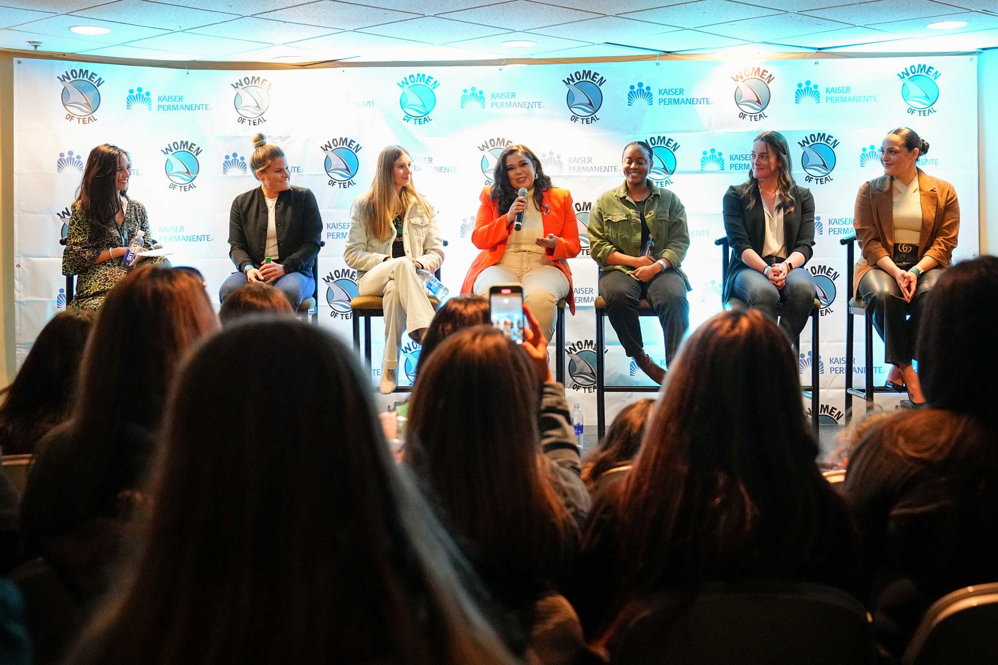 A panel of female professionals and athletes shares experiences and insights during a Women of Teal pre-game event.