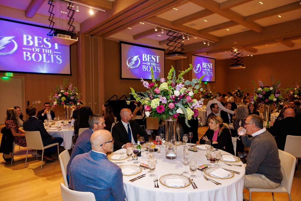 People sitting at round tables in a large conference room for the 'Best of the Bolts' awards ceremony