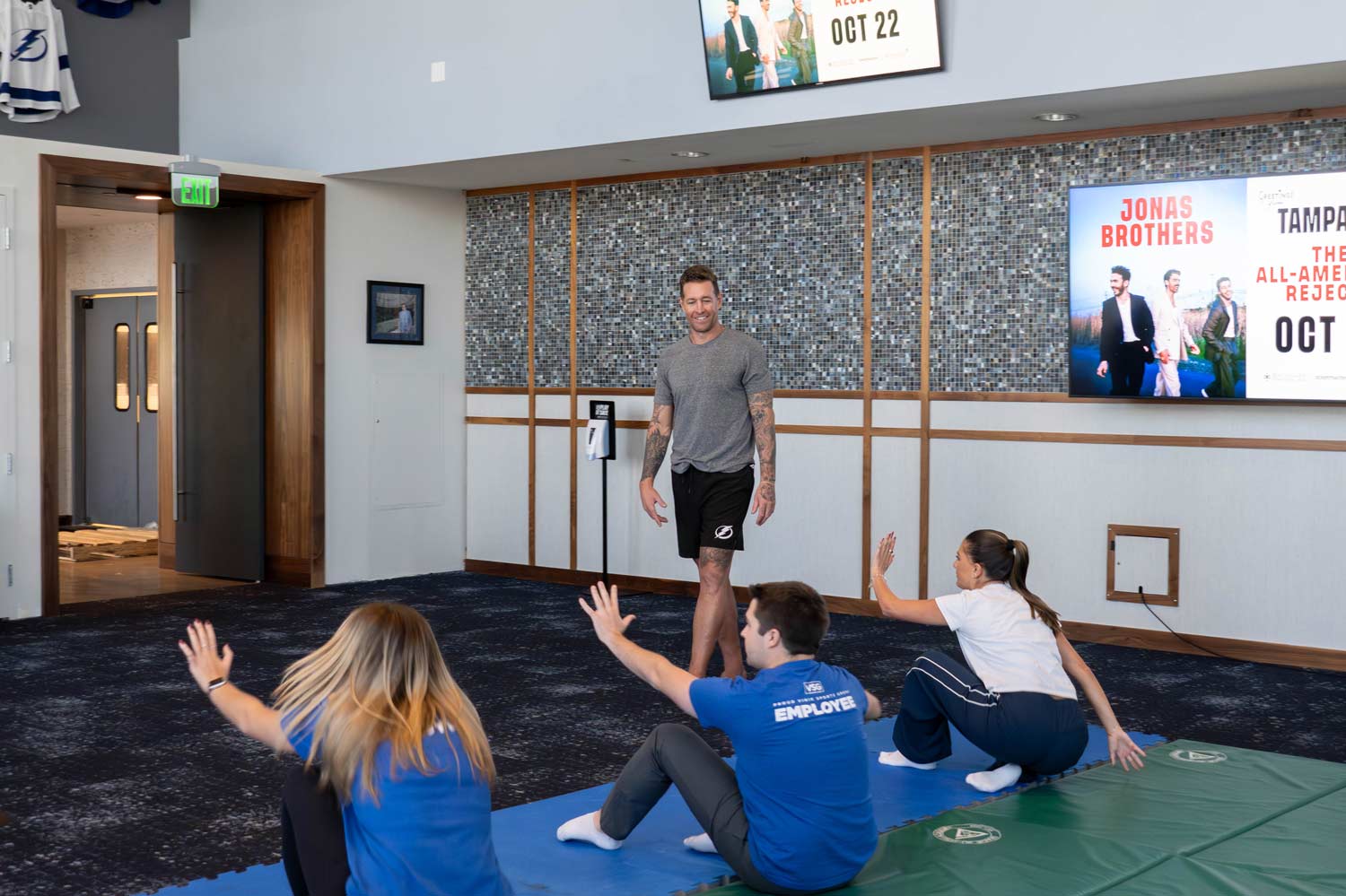 A man teaching a self-defense class to a group of kids